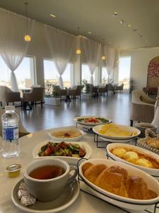 a table with plates of food on a table at فندق ابيات الشمال in Rafha