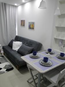 a living room with a table and a couch at SUNNY HALL in Porto De Galinhas +6 photos
