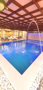 a large swimming pool with a large blue pool at كيان ( KAYAN) in Sūr ash Shiyādī