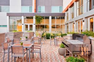 a patio with tables and chairs in front of a building at Element Albuquerque Uptown in Albuquerque