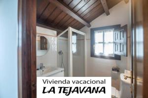 a bathroom with a toilet and a tub and a sink at vivienda vacacional la tejavana in Llames de Pría +14 photos