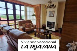 a living room with a couch and a table at vivienda vacacional la tejavana in Llames de Pría