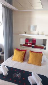 a bedroom with a bed with yellow and red pillows at Teide & Mar Vistas in Tacoronte +36 photos