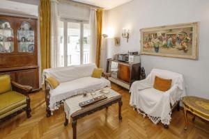 a living room with a couch and chairs and a table at Vintage apartment KOLONAKI in Athens