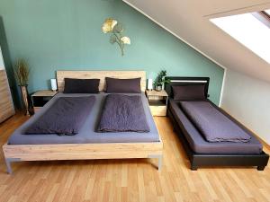 a bedroom with two beds with purple sheets at Ferienwohnung Seeglück im Oberpfälzer Seenland in Schwandorf in Bayern