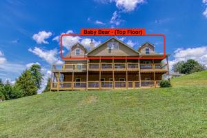 a house on a hill with the words baby bear top floor at Baby Bear by HoneyBearCabins in Sevierville