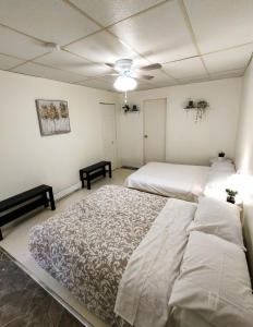 a bedroom with two beds and a ceiling fan at welcome to airbnb in Saint-Jean-sur-Richelieu