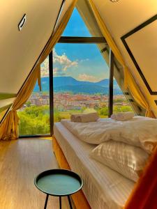 a bedroom with a bed and a large window at MANGATA in Pale