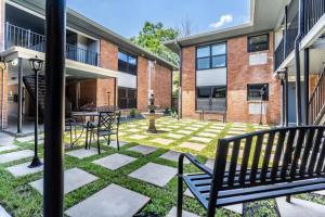 a courtyard with benches and a fountain in a building at Roomy Urban Apartment Montrose! Free Parking #8 in Houston
