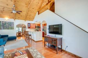 a living room and kitchen with a flat screen tv at Serene South Lake Tahoe Getaway with Spacious Deck! in South Lake Tahoe