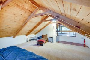 a attic room with a bed and a chair at Serene South Lake Tahoe Getaway with Spacious Deck! in South Lake Tahoe