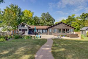 a home with a large yard with a house at Family-Friendly Ottertail Home on Rush Lake! in Ottertail