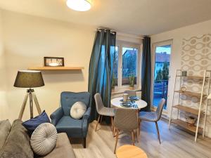 a living room with a couch and a table and chairs at Blu Apartment Ferienwohnung, Businesswohnung, Monteurzimmer in Salzgitter