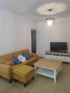 a living room with a couch and a coffee table at Apartamento Buen Recuerdo in Camarena de la Sierra