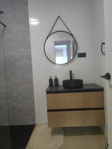 a bathroom with a black sink and a mirror at Apartamento Buen Recuerdo in Camarena de la Sierra