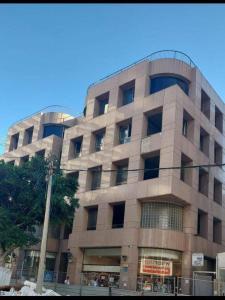 a large building with windows on the side of it at Moon TLV - 4th floor in Tel Aviv
