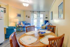 a dining room and living room with a table and chairs at Emerald Isle Vacation Rental, Walk to Beach! in Emerald Isle