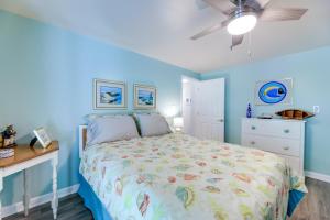 a blue bedroom with a bed and a ceiling fan at Emerald Isle Vacation Rental, Walk to Beach! in Emerald Isle