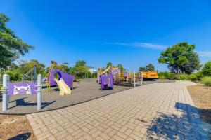 a park with a playground with purple slides at Emerald Isle Vacation Rental, Walk to Beach! in Emerald Isle