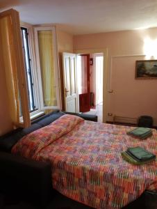 a bedroom with a bed with a colorful bedspread at Casa Corinna, Lake View, Terrace, Private Garage! in Colonno
