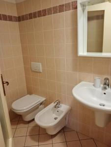 a bathroom with a toilet and a sink at Casa Corinna, Lake View, Terrace, Private Garage! in Colonno