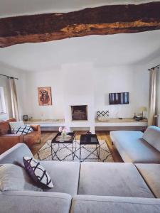 a large living room with couches and tables at Gîte de l'Ourchet in Ramillies
