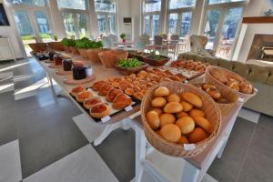 a buffet of food on a table with baskets of food at Datca Doris Hotel in Datca