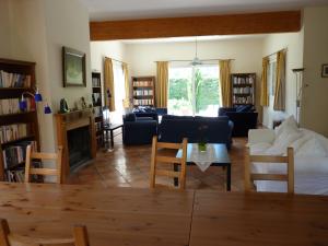 a living room with a couch and a table at La Maison Rose in Saillans