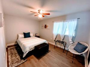 a bedroom with a bed and a ceiling fan at Cute downtown home by Depot Park in Gainesville