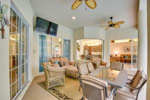 a living room with a couch and a table and chairs at Breezy Palm Coast Golf Retreat with Pool and Lanai! in Palm Coast