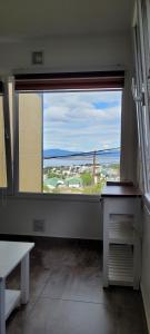 a room with a large window with a view at Lalúan departamento temporario in Ushuaia