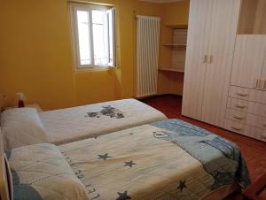 a bedroom with two beds with stars on the sheets at Casa Violetta, Historic Center in Colonno +2 photos