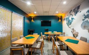 a classroom with tables and chairs and a wall with a world map at Sheraton Tucson Hotel & Suites in Tucson