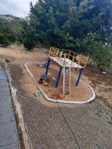 a playground with a ladder in the dirt at Valle dos ipês in Tianguá