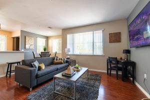 a living room with a couch and a table at Modern Suitevipwifipool2 King Bedsac in Santa Clarita
