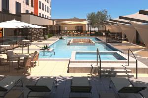 a rendering of a swimming pool with tables and chairs at TownePlace Suites by Marriott Tempe in Tempe