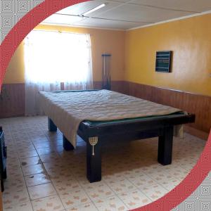 a large bed in a room with a window at RESIDENCIAL RESTORANT BACIAN in Pozo Almonte