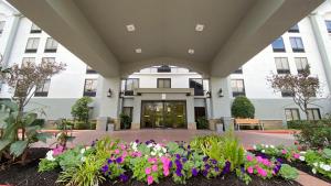 a building with flowers in front of it at Best Western Plus Sugar Land-Stafford in Sugar Land