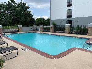 a large swimming pool in front of a building at Best Western Plus Sugar Land-Stafford in Sugar Land
