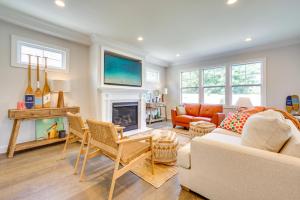a living room with a couch and a fireplace at Sleek Long Branch Vacation Rental with Yard and Patio! in Long Branch