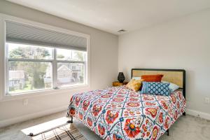 a bedroom with a bed and a large window at Sleek Long Branch Vacation Rental with Yard and Patio! in Long Branch