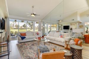 a living room with a couch and a table at Palm Desert Vacation Rental with Pool Access! in Palm Desert