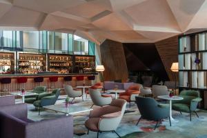 a lobby with tables and chairs and a bar at Anantara The Marker Dublin- A Leading Hotel of the World in Dublin