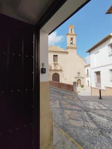 a view from the door of a building with a clock tower at LA CASA DEL VIENTO ATQ in Antequera