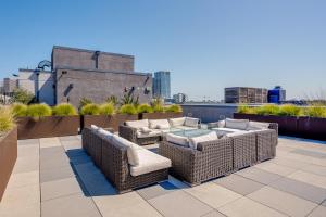 a patio with wicker furniture on a rooftop at San Francisco Condo Less Than 1 Mi to Union Square! in San Francisco