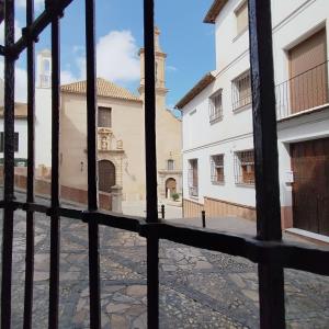 a view of a courtyard through a gate of a building at LA CASA DEL VIENTO ATQ in Antequera