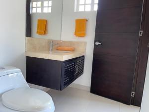 a bathroom with a sink and a toilet at Casa HESTIA Condominio Campestre el Peñon Girardot in Girardot +25 photos