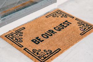 a welcome mat on the floor next to a window at Sun & Fun 3BR Beach Home with Pool & Tiki Bar in Jacksonville