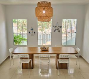 a dining room with a wooden table and chairs at The Pelican Poshtel in San Juan