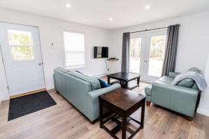 a living room with two couches and a table at The Apartment in Deer Lake